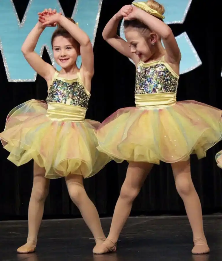 Preschool and kindergarten dancers performing together in colorful costumes