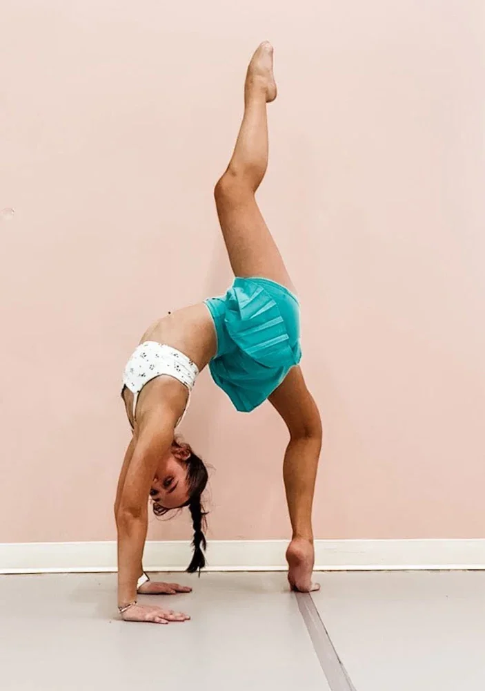 Student performing a dance pose in the Spotlight Dance Company studio